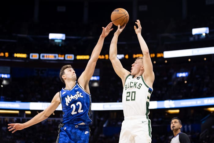 Orlando Magic forward Franz Wagner (22) attempts to block Milwaukee Bucks guard AJ Green (20)